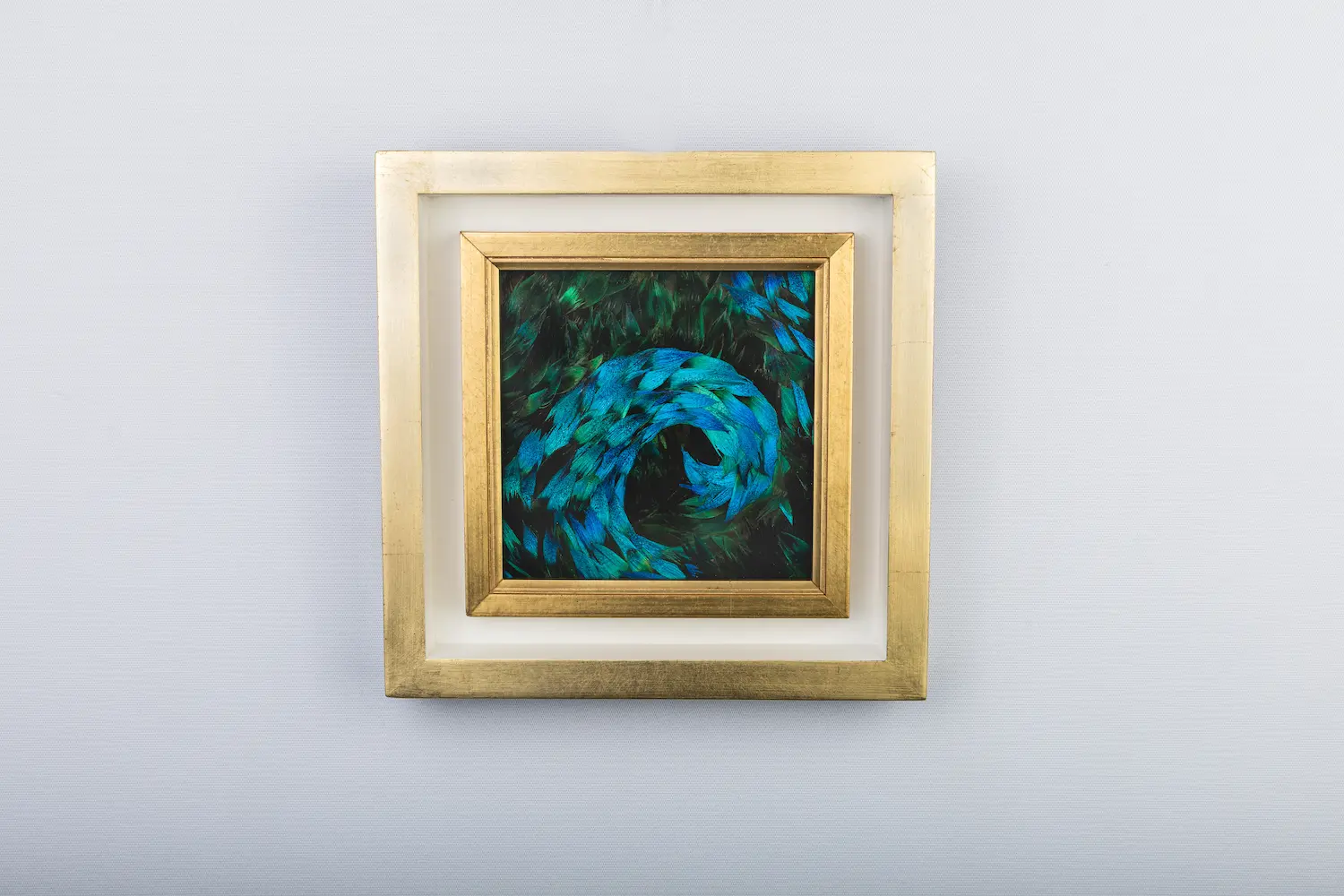 Blue wave painting made from natural peacock feathers in blue and blue/green on the front