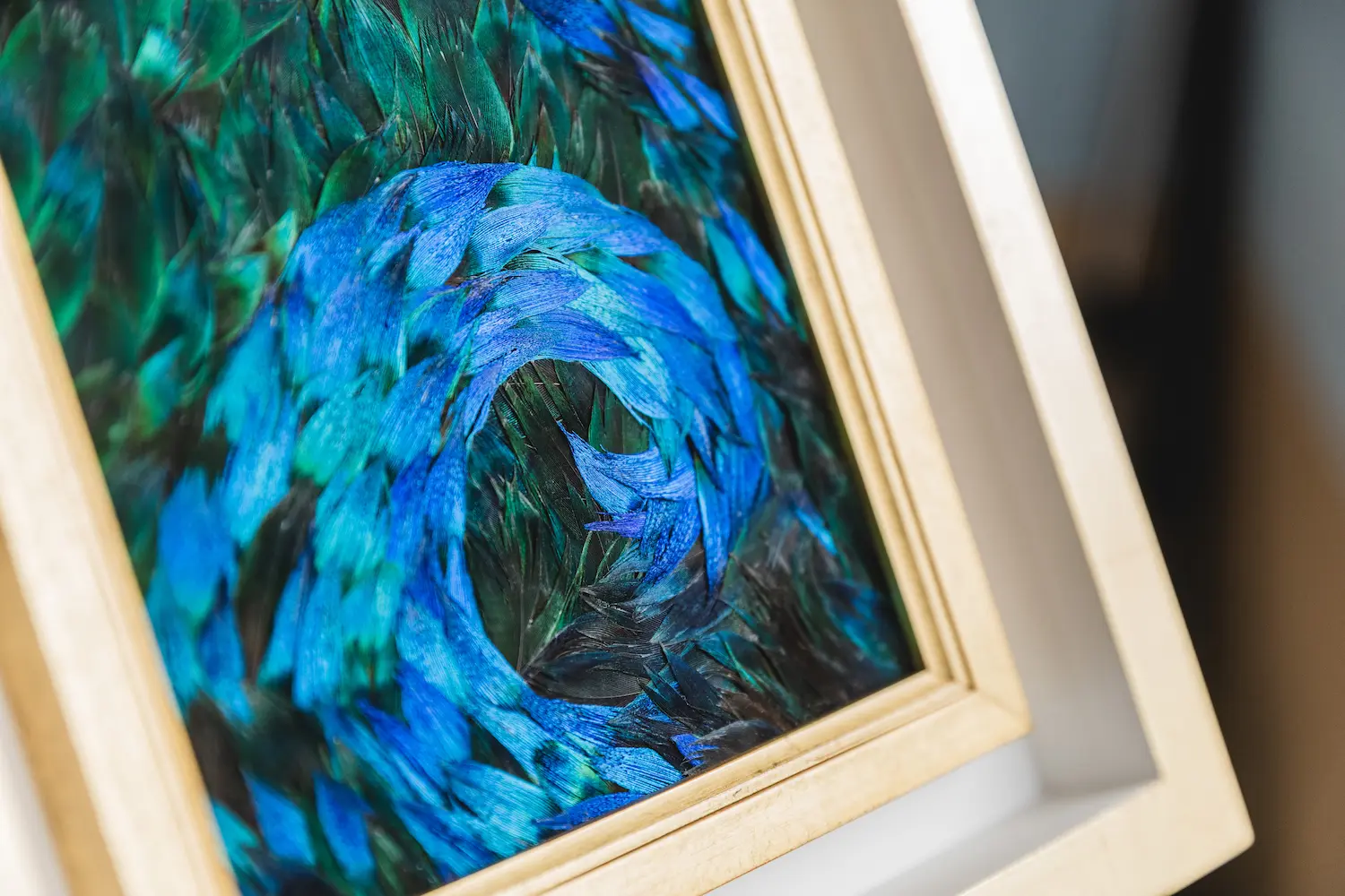 Blue wave painting made from natural blue and blue/green peacock feathers